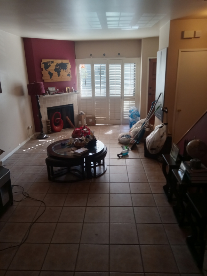 Before deep cleaning service in Los Angeles showing a messy living room with scattered items